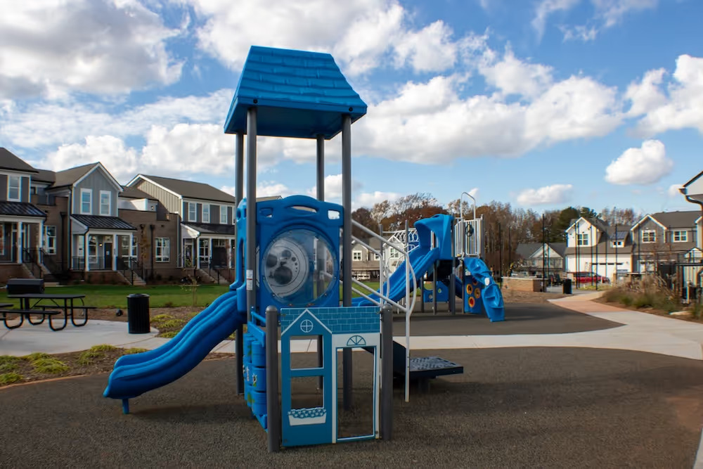 Outdoor playground with slide at Townhomes at Bridlestone