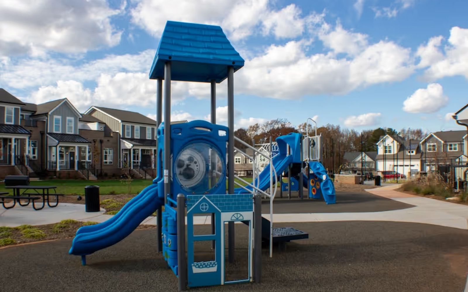 Outdoor playground with slide at Townhomes at Bridlestone