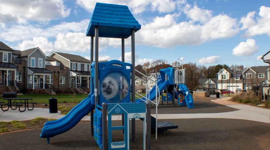 Outdoor playground with slide at Townhomes at Bridlestone